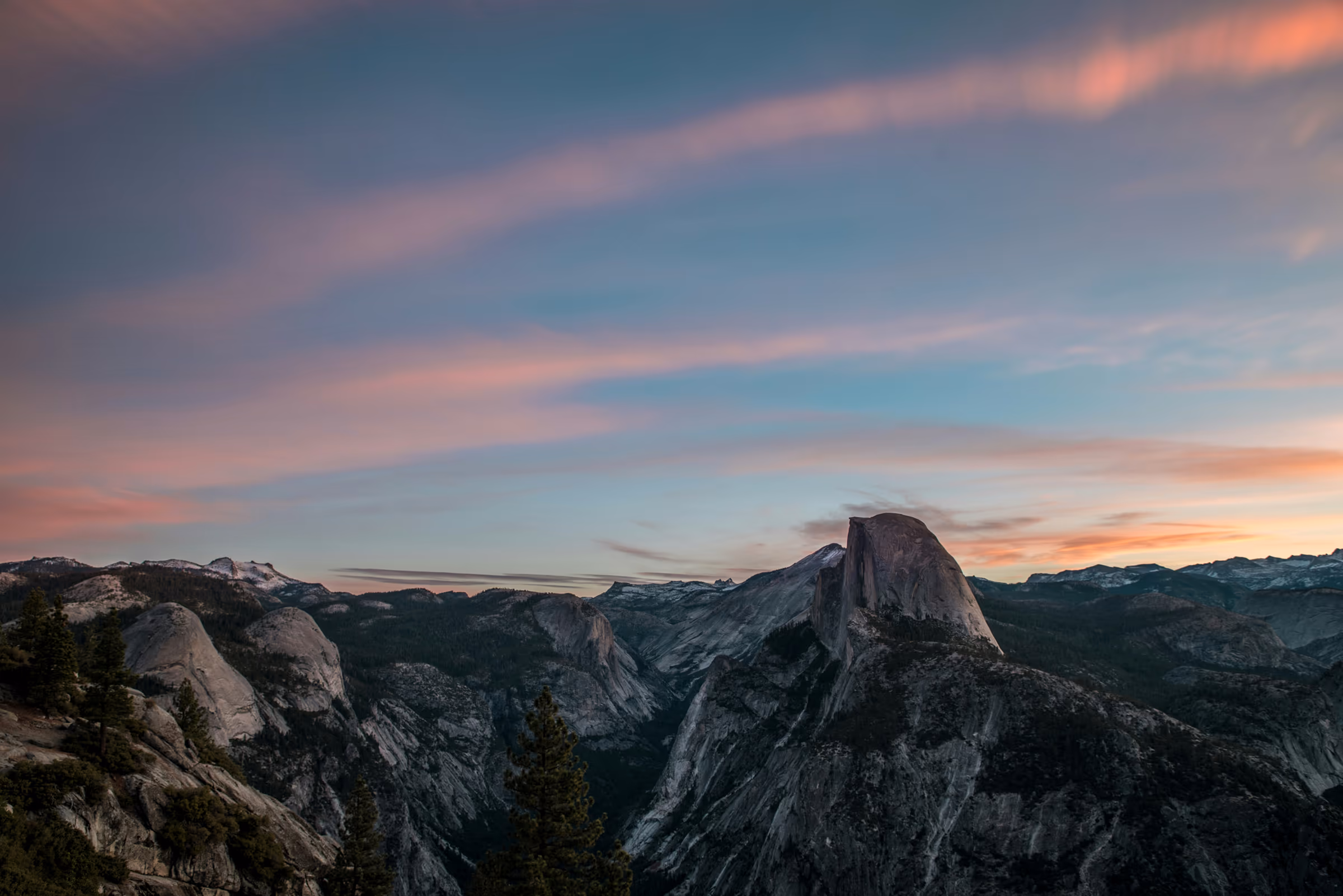 Half Dome and Yosemite Valley under pink sunset clouds