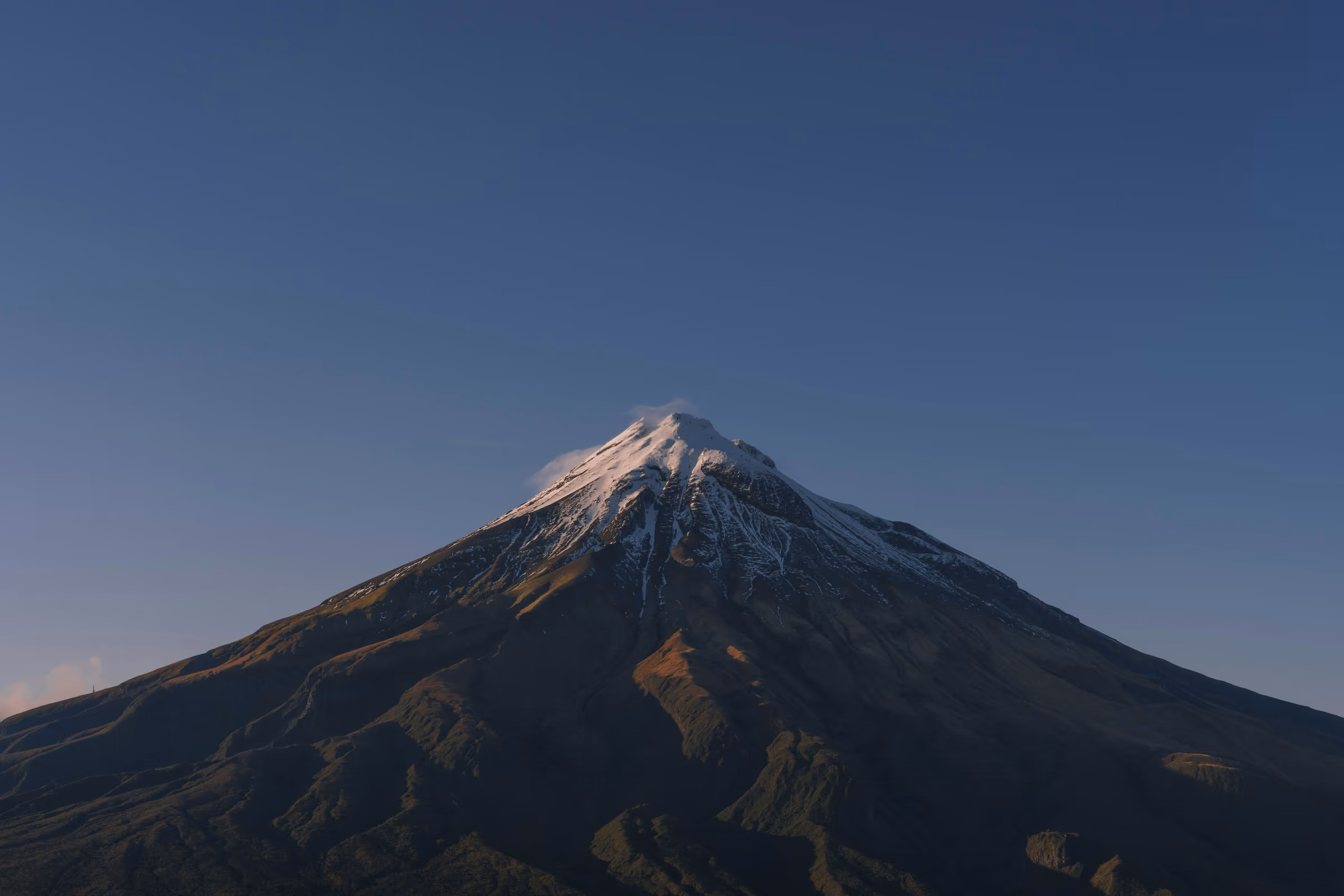 Snow-capped Mount Taranaki under a clear blue sky